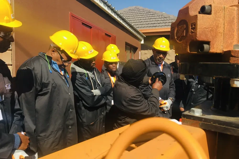 Trainees learning Hydraform machine operation at the Academy
